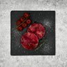 Yellowfin Tuna Burger Patty on slate with cherry tomatoes and herbs in Singapore (flatlay).